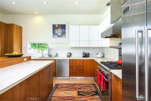 kitchen featuring decorative backsplash, premium appliances, modern cabinets, brown cabinets, and light countertops