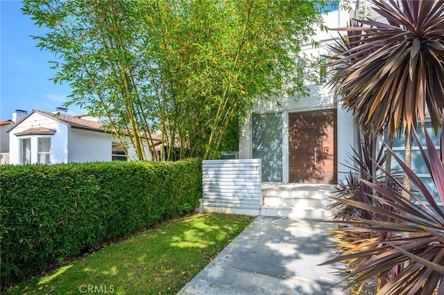 entrance to property featuring stucco siding