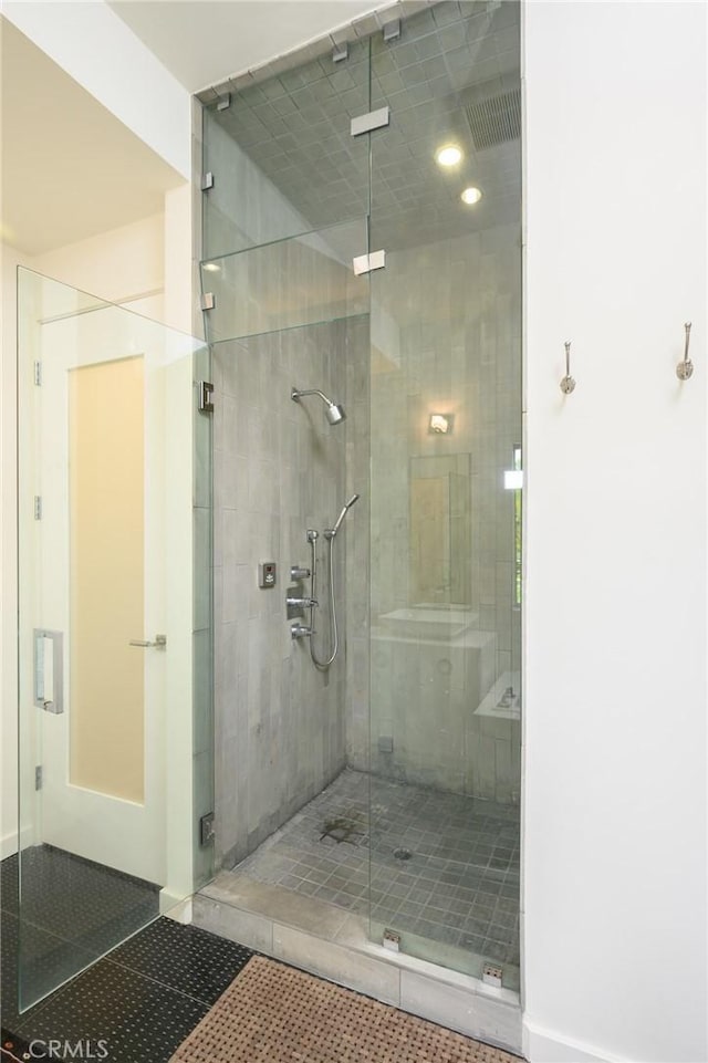 full bathroom featuring a stall shower and tile patterned floors