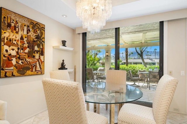 tiled dining space with a chandelier