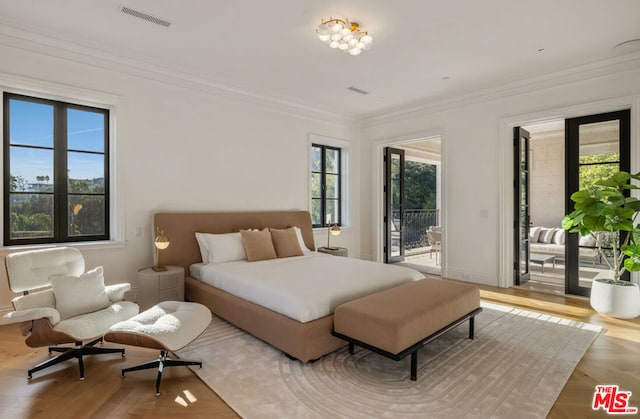 bedroom with light hardwood / wood-style flooring, access to outside, and ornamental molding