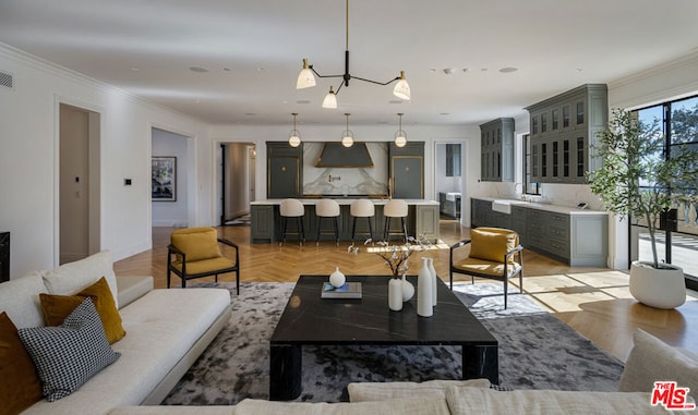 living room featuring crown molding, sink, and light parquet floors