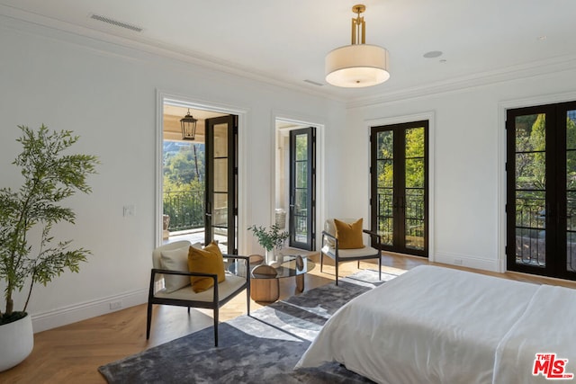 bedroom with light parquet floors, crown molding, and french doors