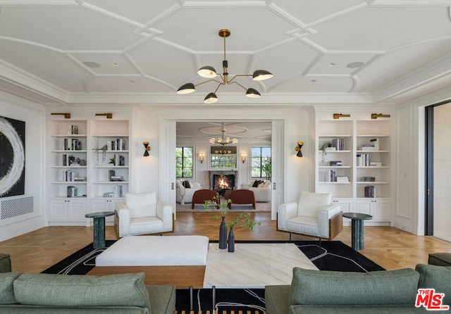 living room with an inviting chandelier, built in features, parquet flooring, and coffered ceiling