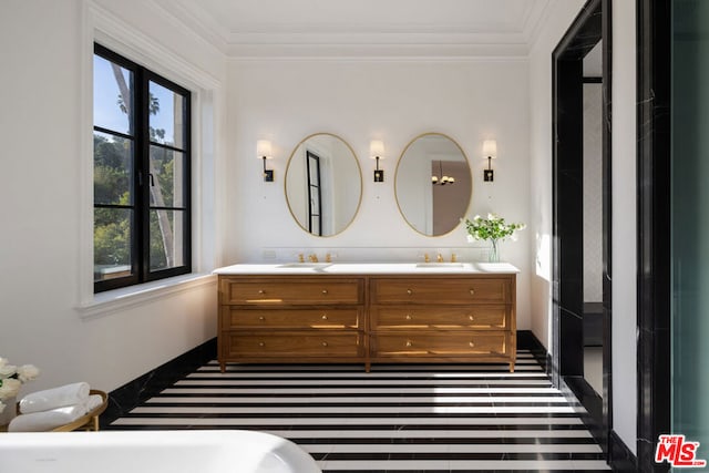 bathroom with ornamental molding and vanity