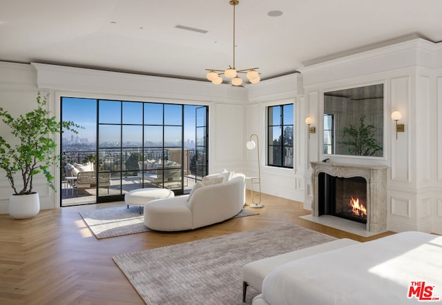 bedroom with a premium fireplace, vaulted ceiling, access to exterior, and light parquet floors