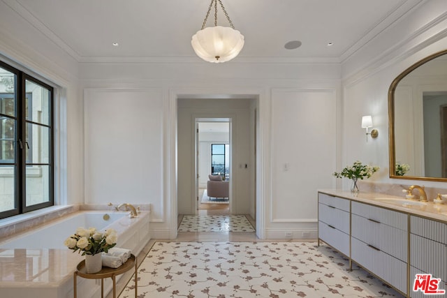 bathroom with vanity, ornamental molding, and a tub to relax in