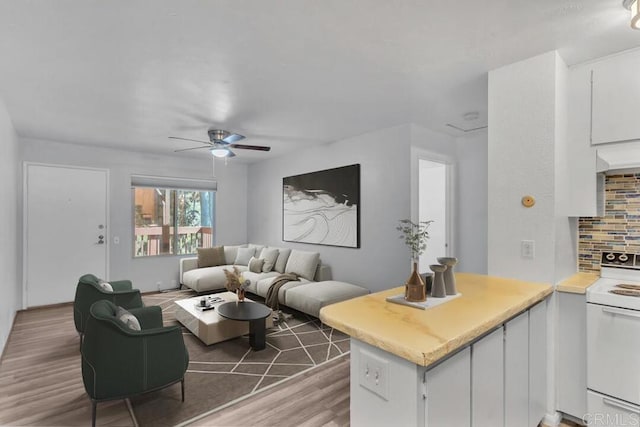 living room with wood-type flooring and ceiling fan