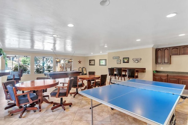 rec room featuring crown molding and light tile patterned flooring