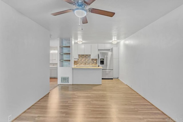 unfurnished living room with ceiling fan and light hardwood / wood-style floors