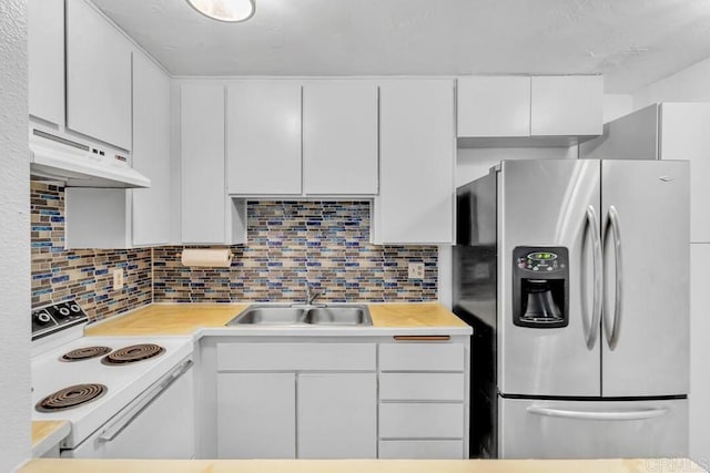 kitchen featuring white cabinetry, sink, stainless steel fridge, and white range with electric stovetop