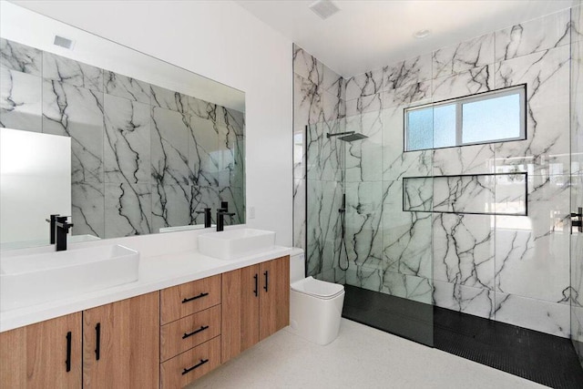 bathroom featuring toilet, vanity, and tiled shower