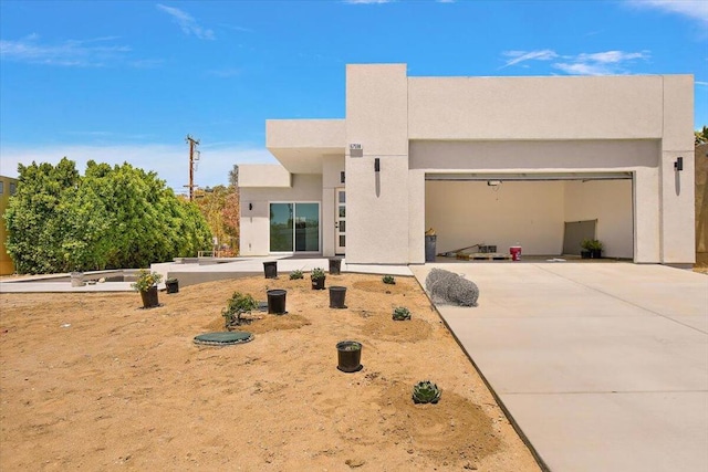 pueblo-style house featuring a garage