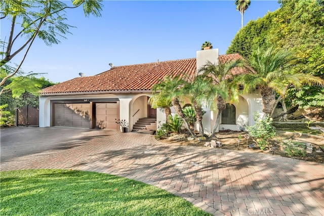 mediterranean / spanish home with a garage