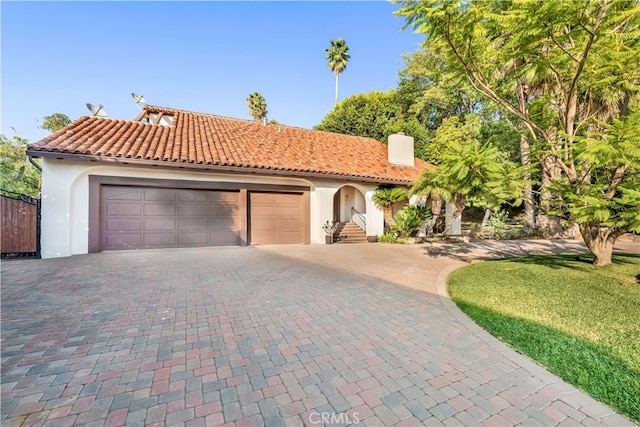 mediterranean / spanish-style home with a garage