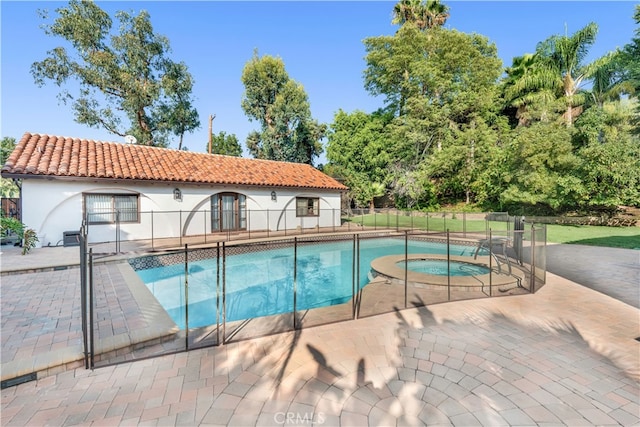 view of swimming pool with an in ground hot tub and a patio area