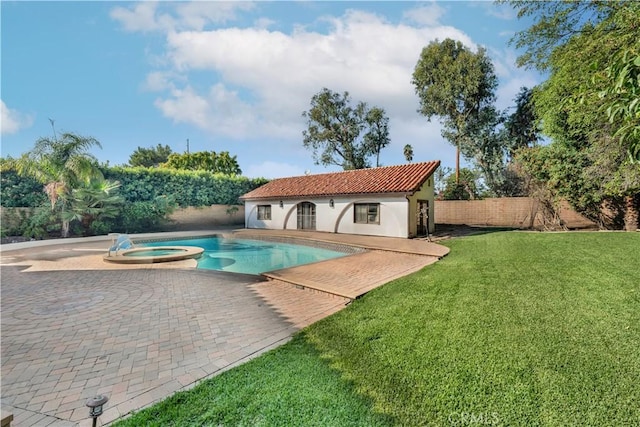 view of swimming pool with a patio, an in ground hot tub, a yard, and an outdoor structure