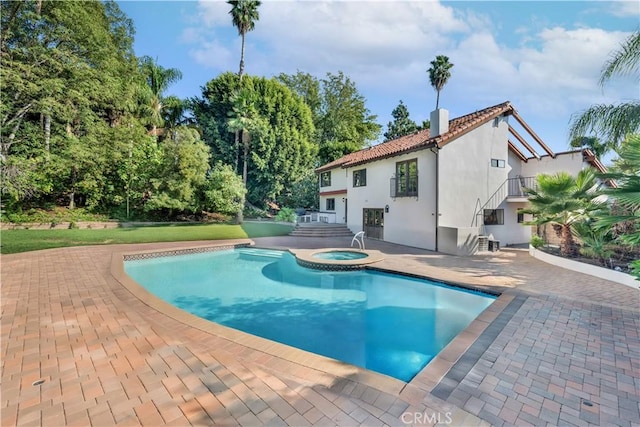 view of swimming pool featuring an in ground hot tub and a patio