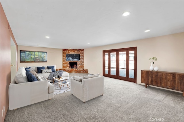 living room featuring a brick fireplace, light carpet, and a wealth of natural light