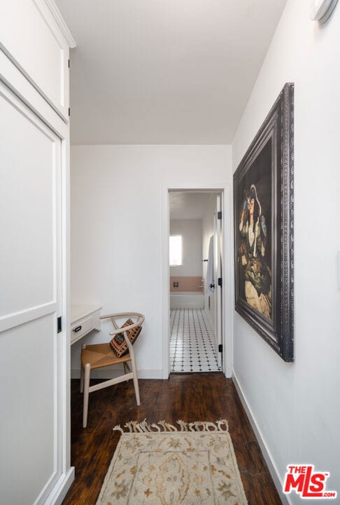 hall with dark wood-type flooring