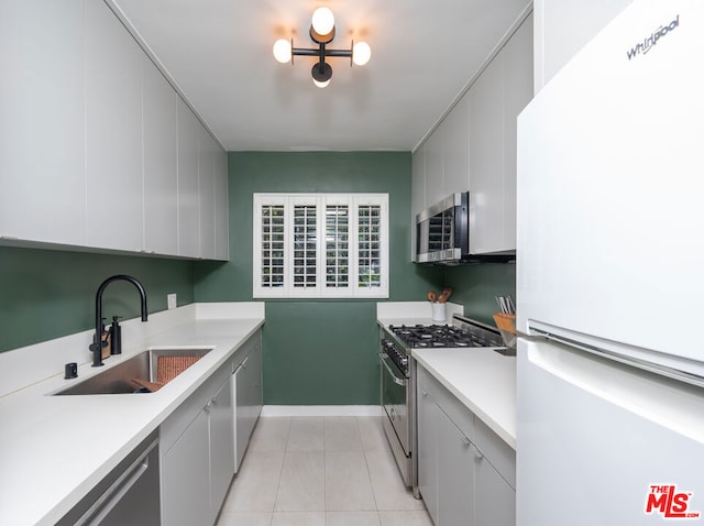 kitchen with sink, light tile patterned flooring, and stainless steel appliances