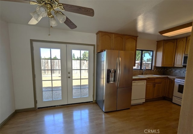 kitchen with french doors, stainless steel appliances, a wealth of natural light, and sink