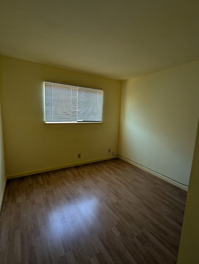 unfurnished room featuring dark hardwood / wood-style floors