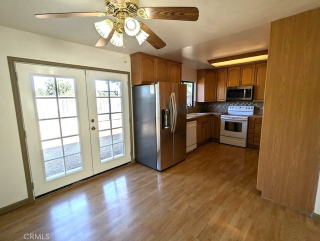 kitchen with ceiling fan, light hardwood / wood-style flooring, sink, french doors, and stainless steel appliances