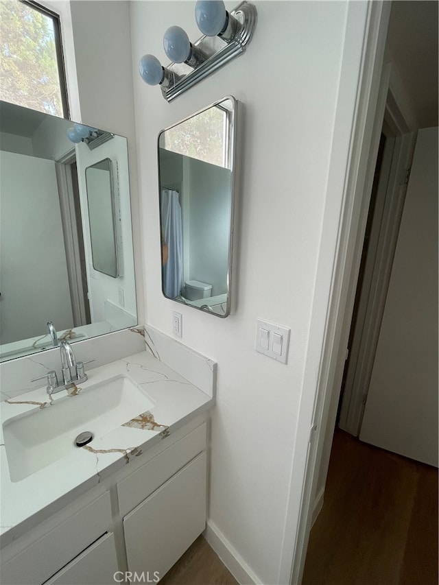 bathroom featuring vanity and hardwood / wood-style floors