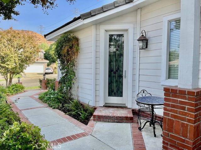 doorway to property with a patio area