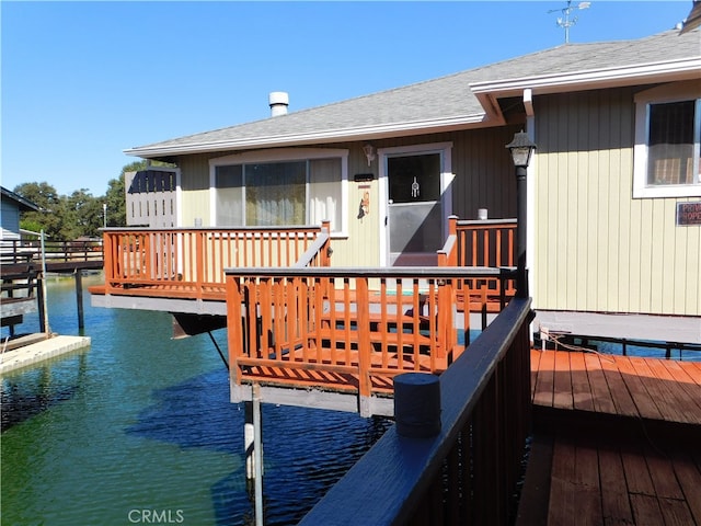 deck featuring a water view and a dock