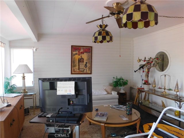 carpeted living room with beamed ceiling