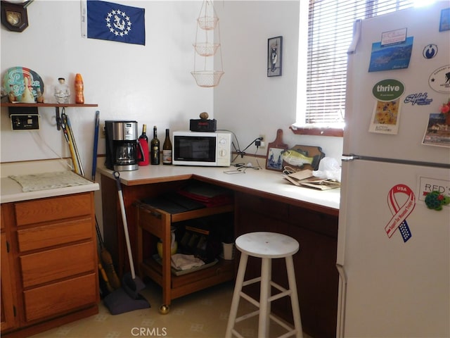 kitchen with hanging light fixtures and white appliances