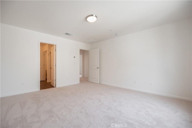 spare room with light colored carpet