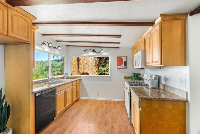 kitchen with sink, stainless steel gas stove, stone countertops, light hardwood / wood-style flooring, and dishwasher