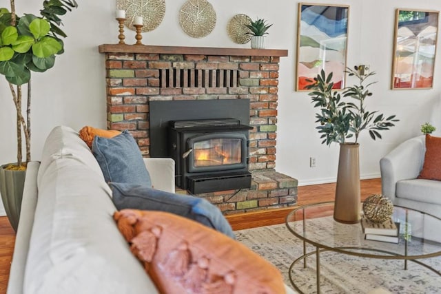 living room featuring hardwood / wood-style flooring and a wood stove