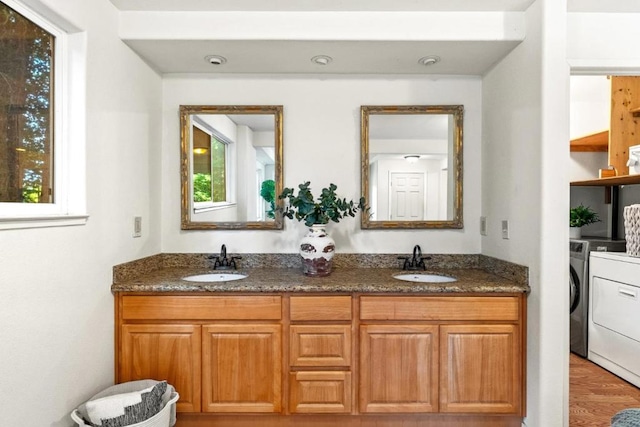 bathroom featuring vanity, washer and clothes dryer, and wood-type flooring