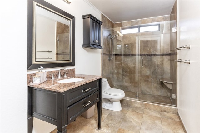 bathroom featuring toilet, vanity, and an enclosed shower