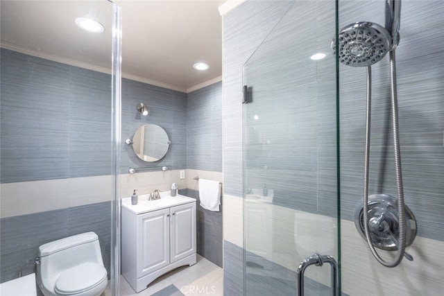 bathroom featuring tile walls, toilet, vanity, and ornamental molding