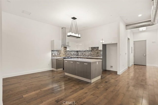433 Pine Ave Unit 304, Long Beach, CA 90802 - kitchen featuring island exhaust hood, white cabinetry, backsplash, a kitchen island, and dark wood finished floors
