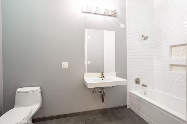 full bathroom featuring toilet, washtub / shower combination, and tile patterned flooring