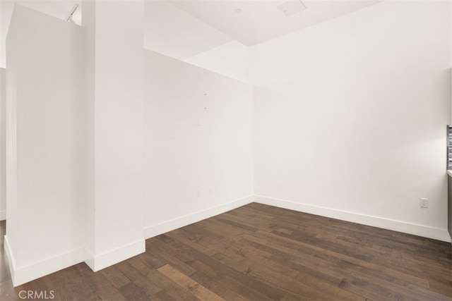 empty room featuring dark hardwood / wood-style flooring