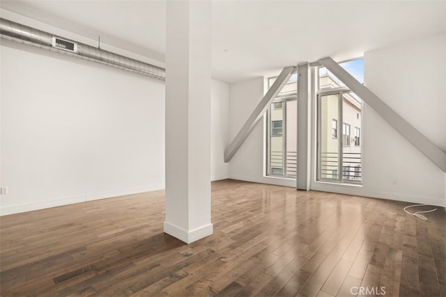 additional living space featuring dark hardwood / wood-style flooring