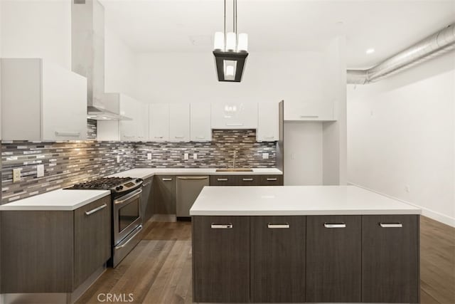 kitchen featuring hanging light fixtures, white cabinetry, dark wood-type flooring, dark brown cabinetry, and stainless steel appliances