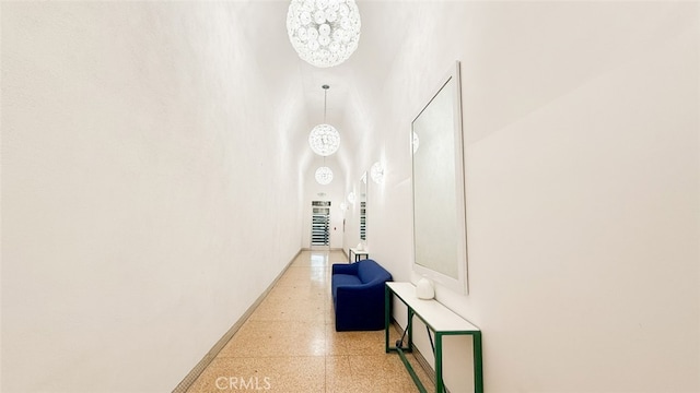 hall with a chandelier and a towering ceiling