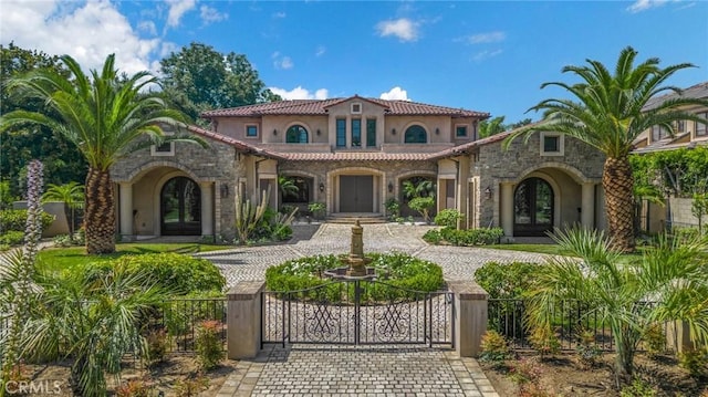 mediterranean / spanish home featuring french doors