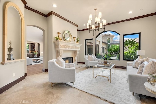 living room with an inviting chandelier and crown molding