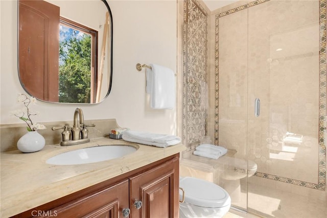 bathroom with vanity, toilet, and walk in shower