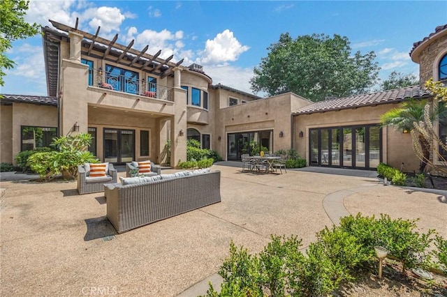 back of house with an outdoor hangout area and a patio