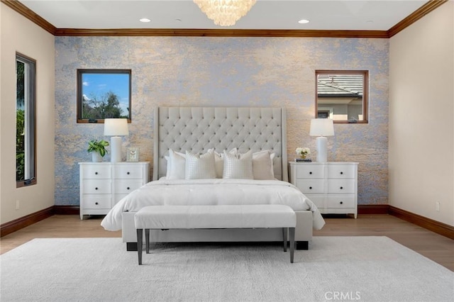 bedroom with a chandelier, crown molding, and light hardwood / wood-style flooring